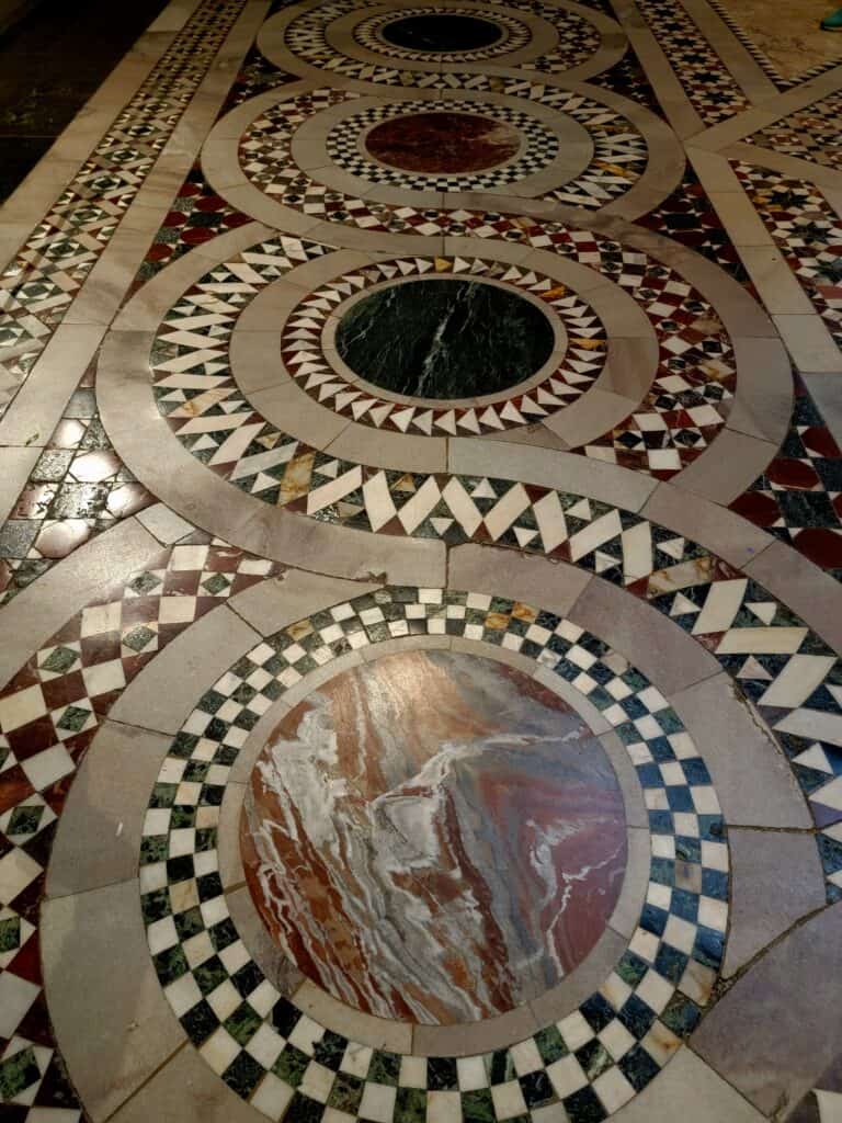 Inlaid marble of red, white, black, and grey in figure 8 shapes