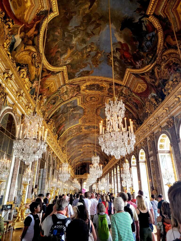 The Hall of Mirrors in Versailles with a crowd