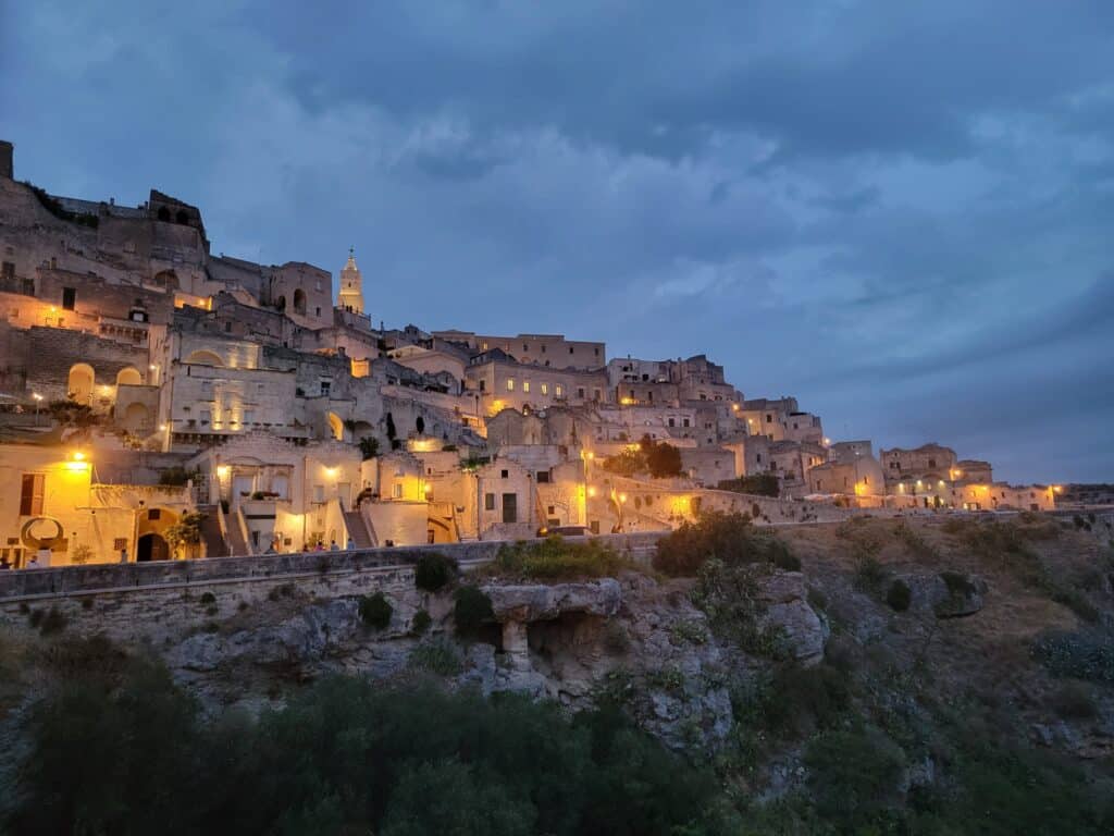 Matera, the oldest city in Italy, glows golden at dusk after our Matera walking tour