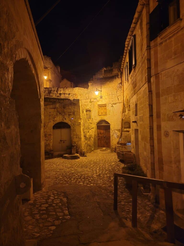 A stone alleyway at night in Matera It