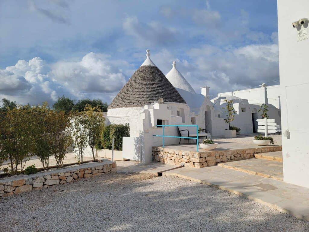 A round trulli hut with two conical stone roofs