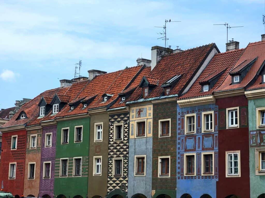 A line of brightly colored Renaissance row houses with shops on the ground floor