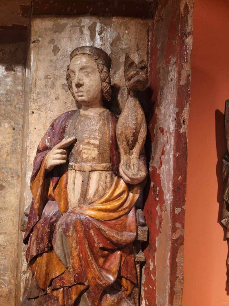 A wooden carving of a medieval saint