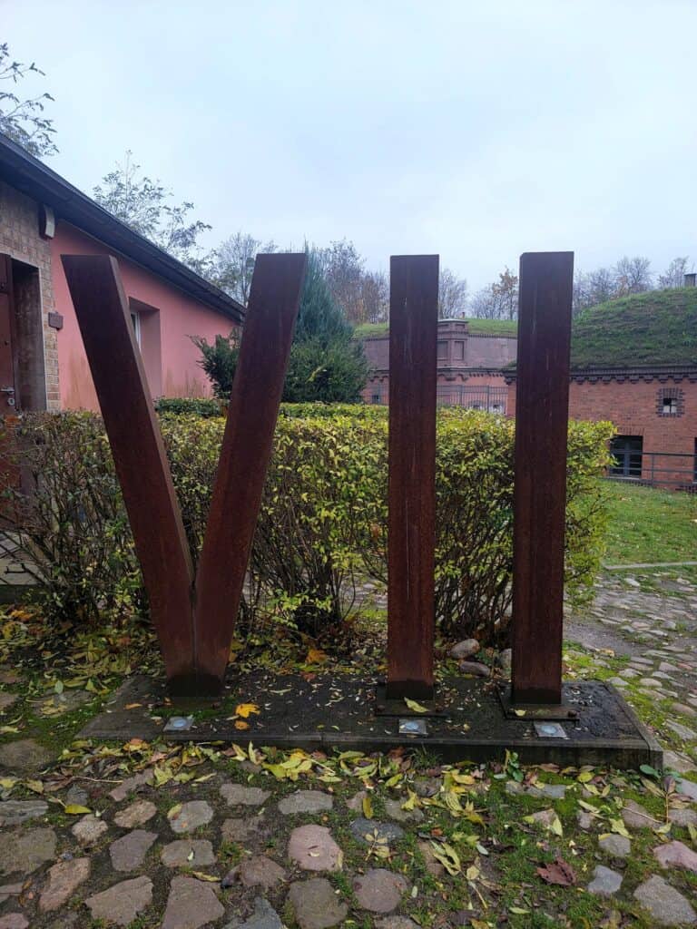 Huge iron Roman numerals VII stand in a courtyard