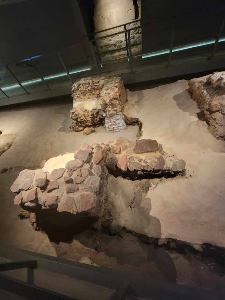 Stone remains of the old altar now underground in a museum-like display