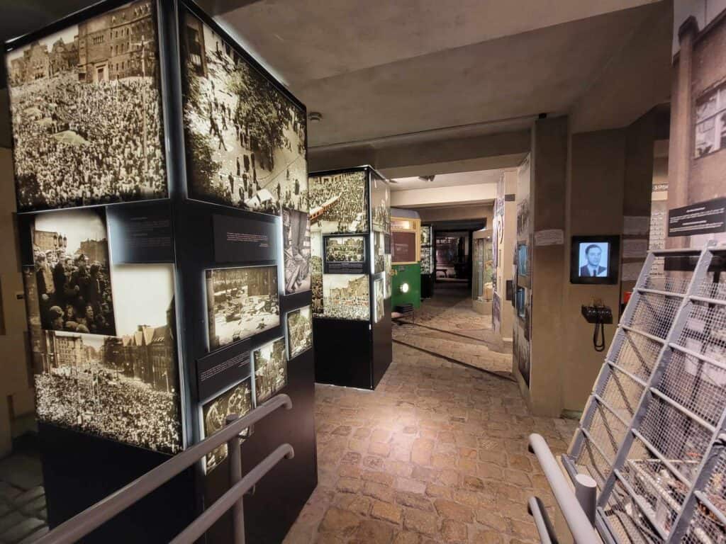 A long museum corridor fillied with black and white photographs of the Poznan uprising