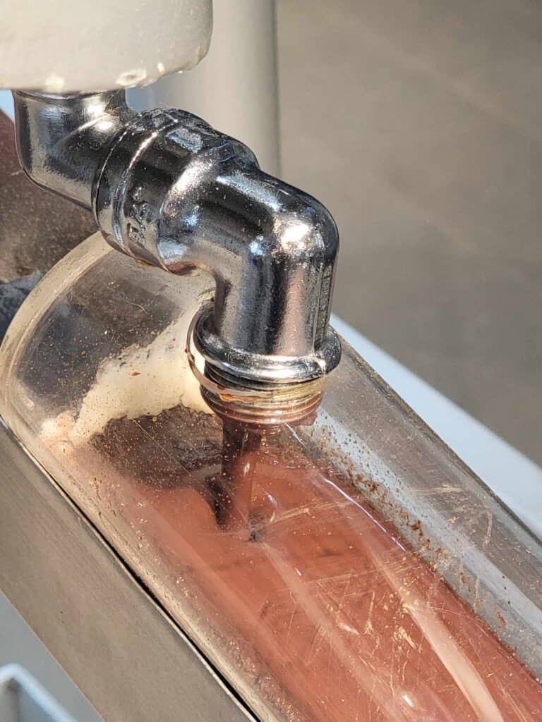 A spigot with flowing milk chocolate in the Chocolate Museum in Cologne
