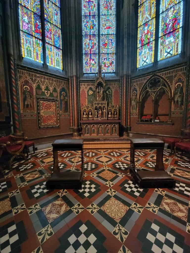 The chapel of the three kings with colorful and intricate tile floor and three double panes of stained glass