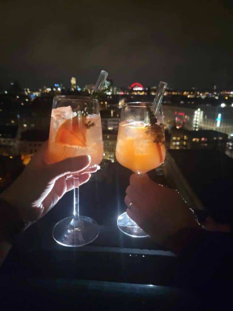 Toasting with an Aperol spritz on the rooftop bar overlooking Cologne