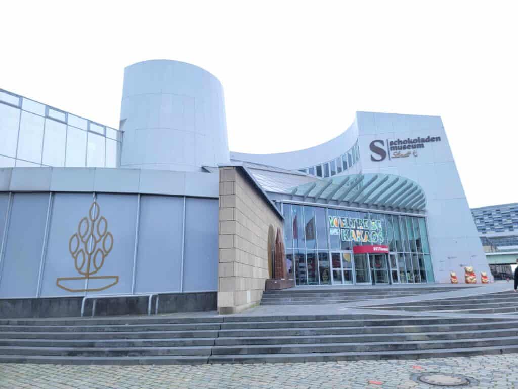 Stairs lead to the Chocolate Museum in Cologne with a glass front.