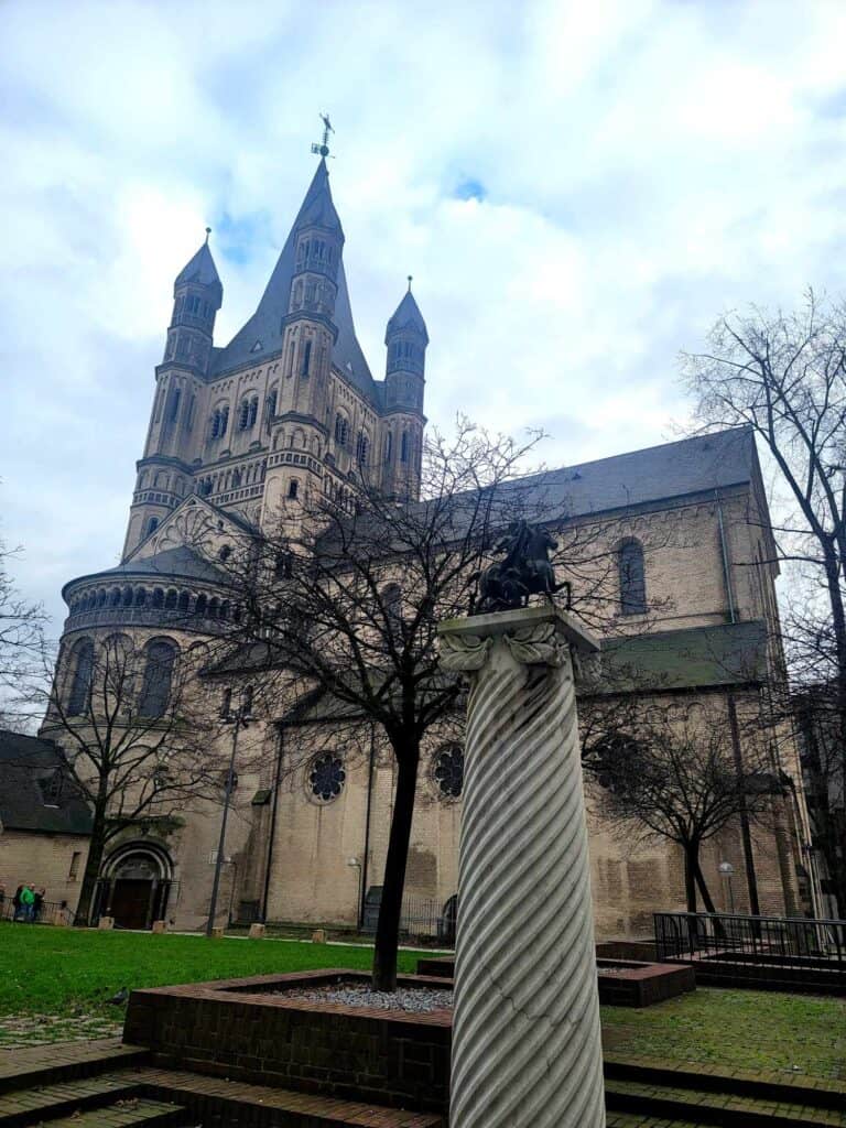 Great St. Martin's romanesque church from the outside with a statue of St. Martin