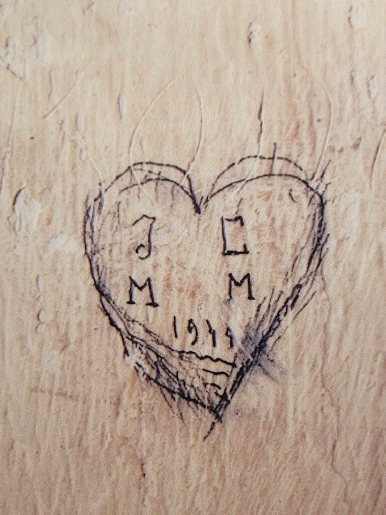 A rudimentary carved heart with the initials JC and MM, and "1944"