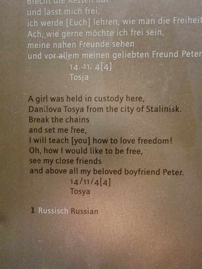 Text reads:
A girl was held in custody here,
Danilova Tosya from the city of Stalinis
Break the chains and set me free,
I will teach you how to love freedom!
Oh, how I would like to be free, see my close friends, and above all my beloved boyfrien Peter. 14/11/44 Tosya