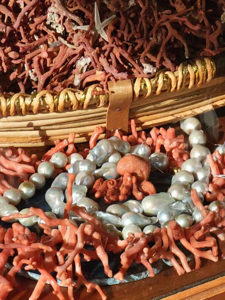 A pile of coral and pearl jewelry in a gift shop in Ravello