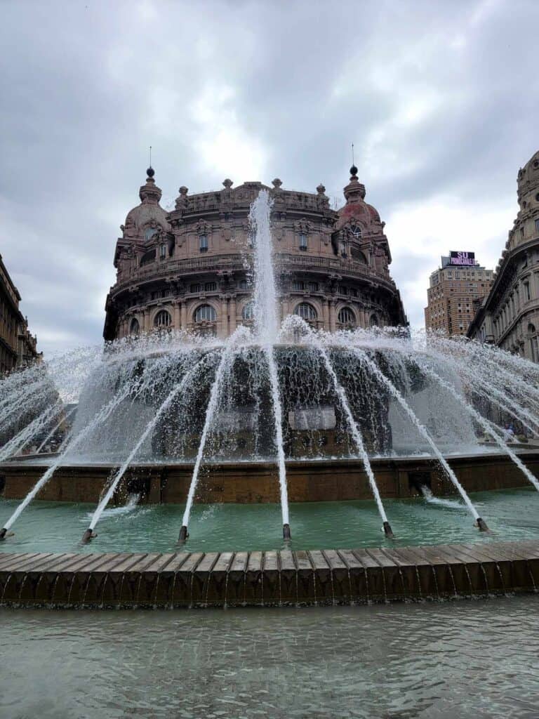 A round fountain with many spigots shooting water up from the sides and into a central stone bowl