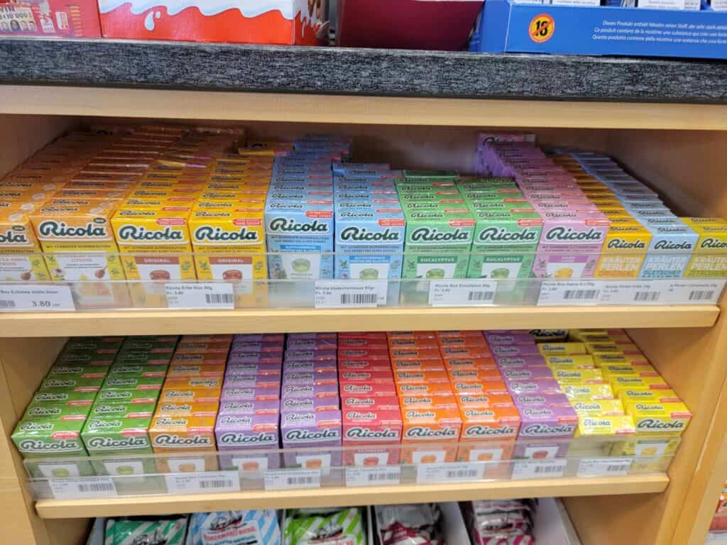 Shelves filled with different colored packages of Ricola cough drops