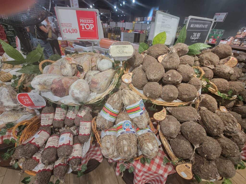 Baskets and baskets of cured meats, some wrapped in twine