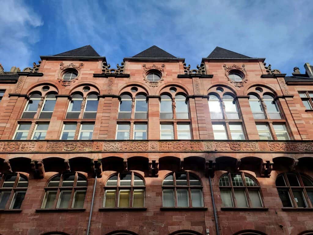 A red stone building with arched windows