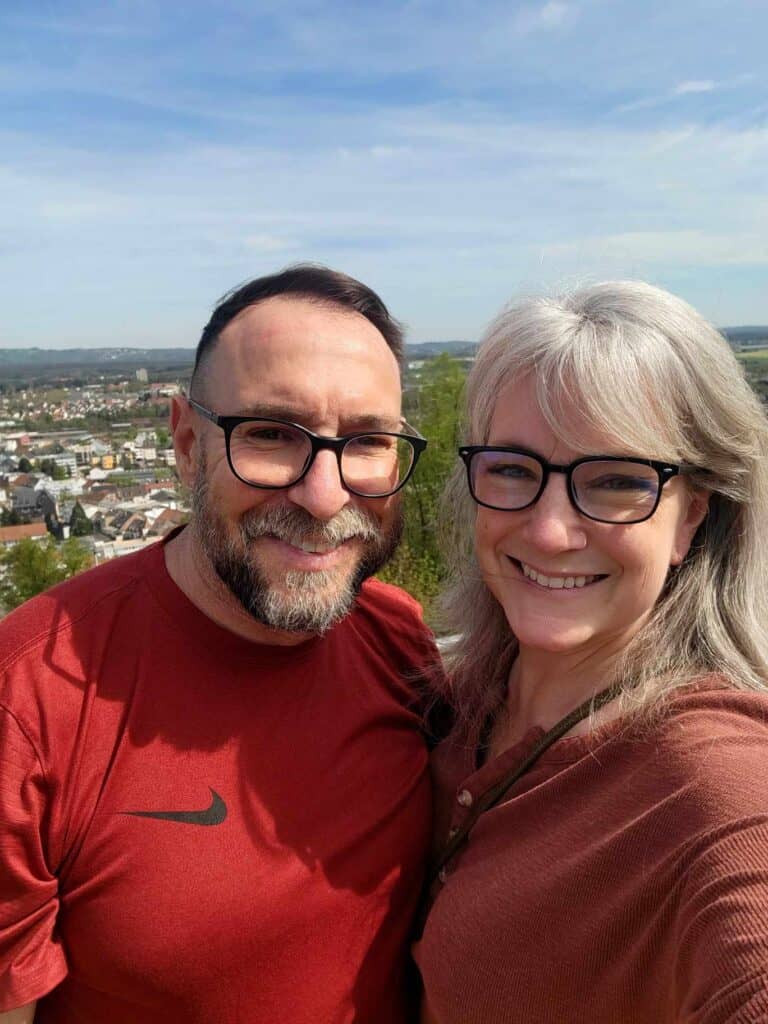 A smiling couple with a landscape below