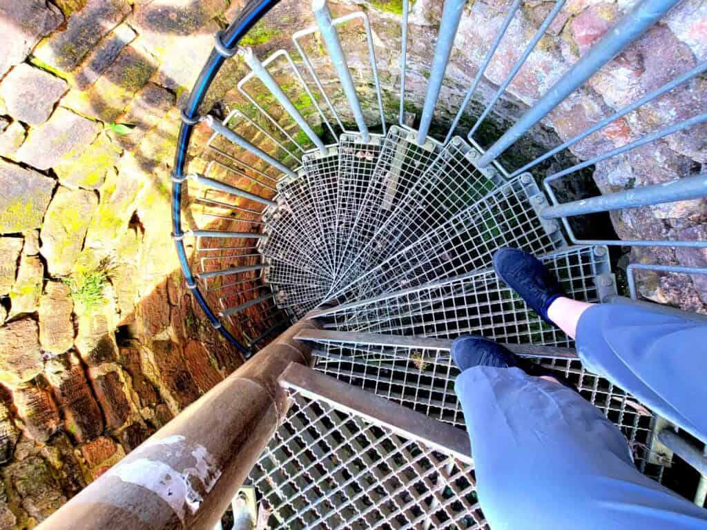 A very narrow metal spiral staircase going down