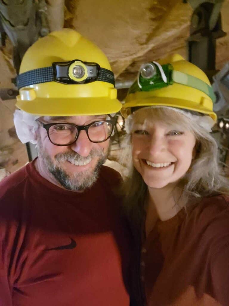 A smiling couple in yellow hard hats