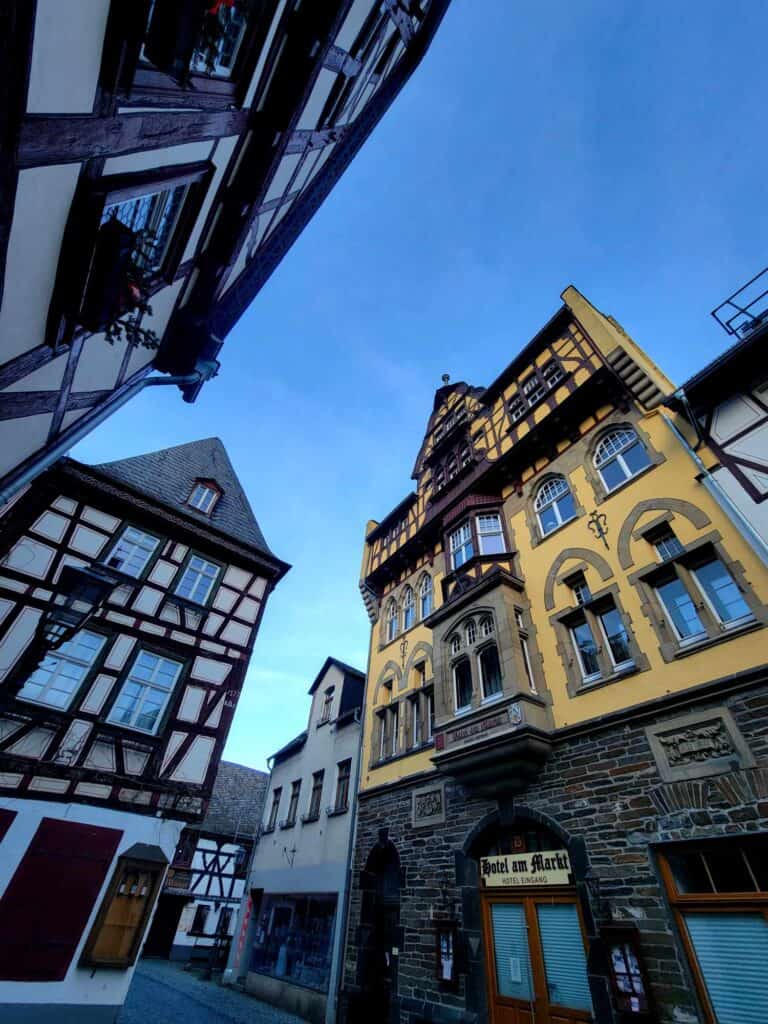 Red and white half timbered buildings and one yellow building with grey half timbering