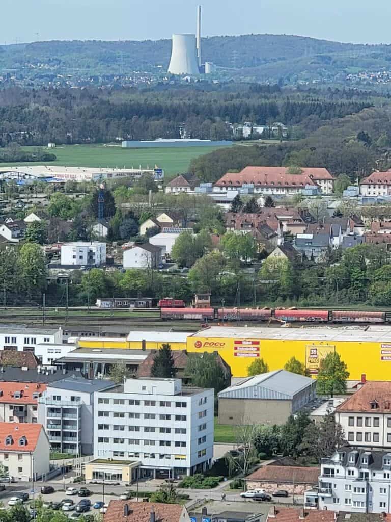 Apartment buildings in the foreground, forest in the mid-distance, a nuclear reactor in the distance.