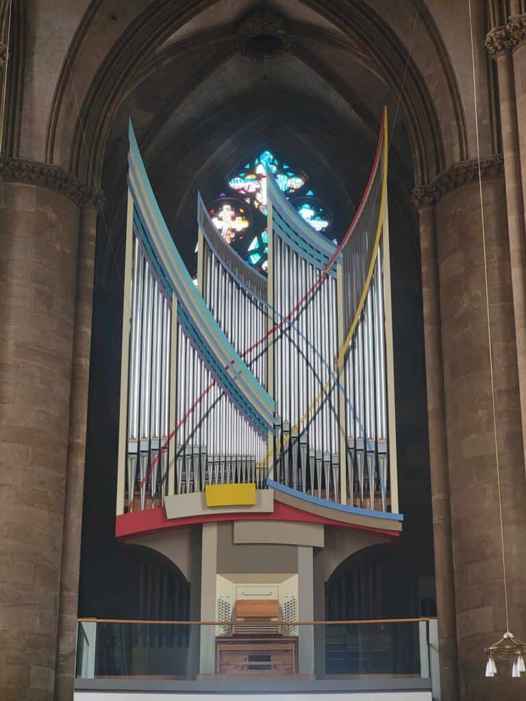 A set of church organ pipes trimmed in primary colors and with a modern angular design