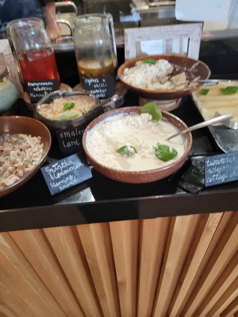 Bowls of cottage cheese, lard, and herring salad.