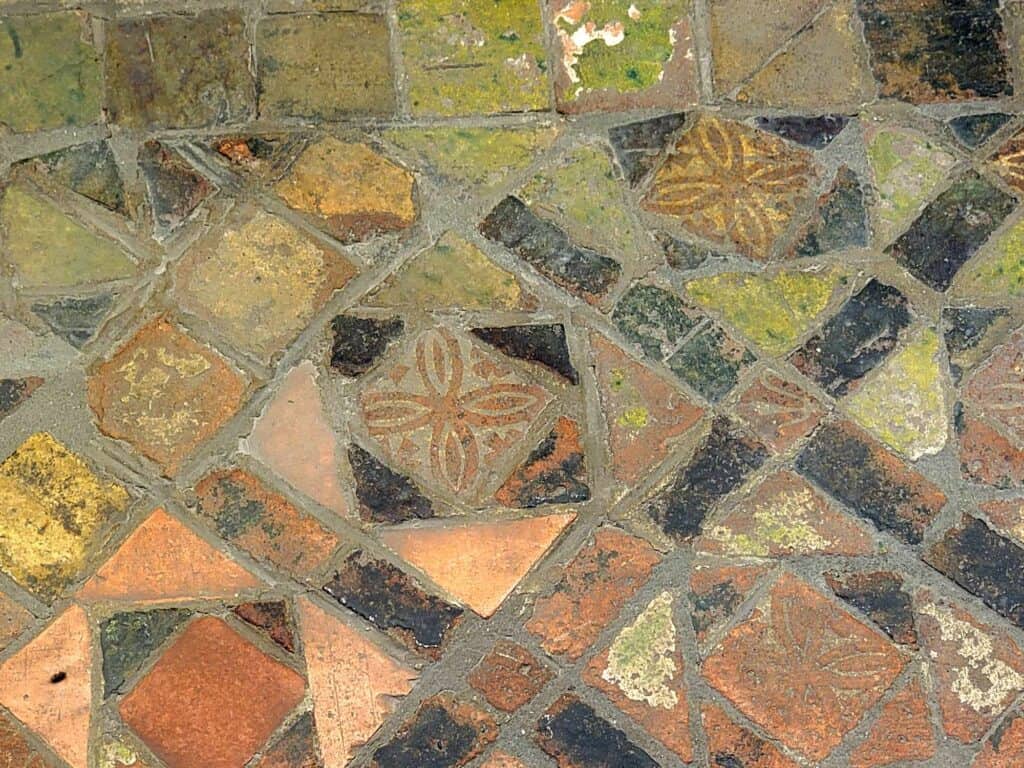 A mosaic floor in green, black, and orange