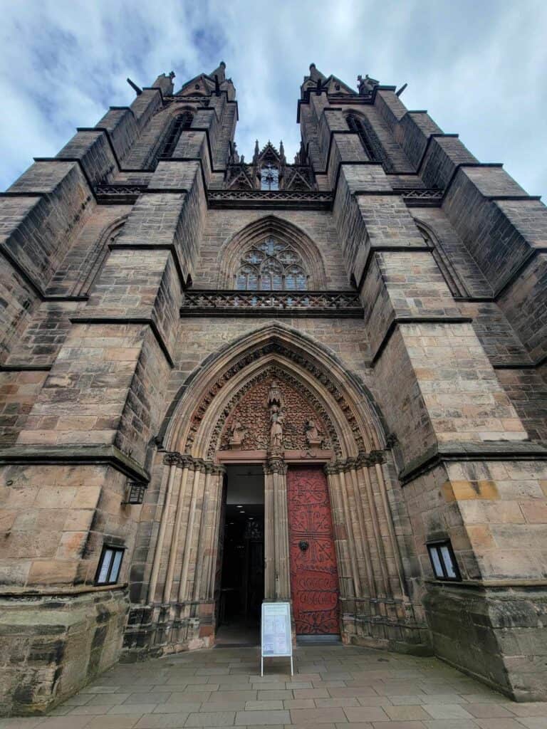 The elaborate carved stone door of a two-towered stone church