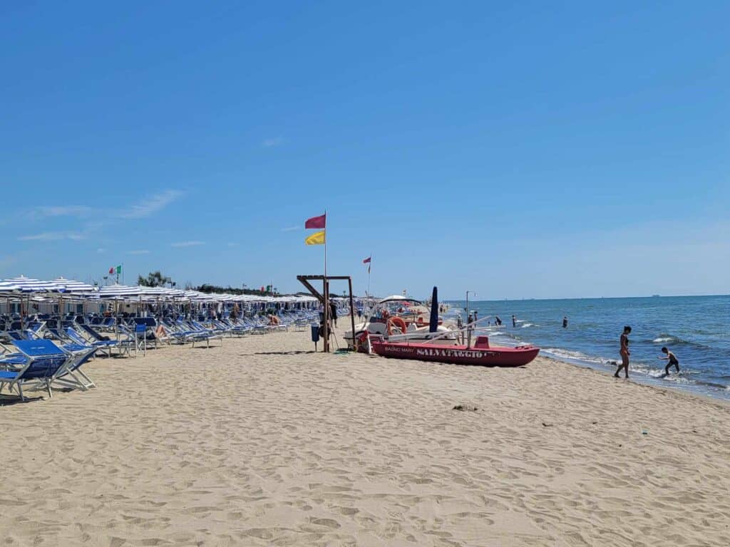 A lifeguard's small red boat on the beach