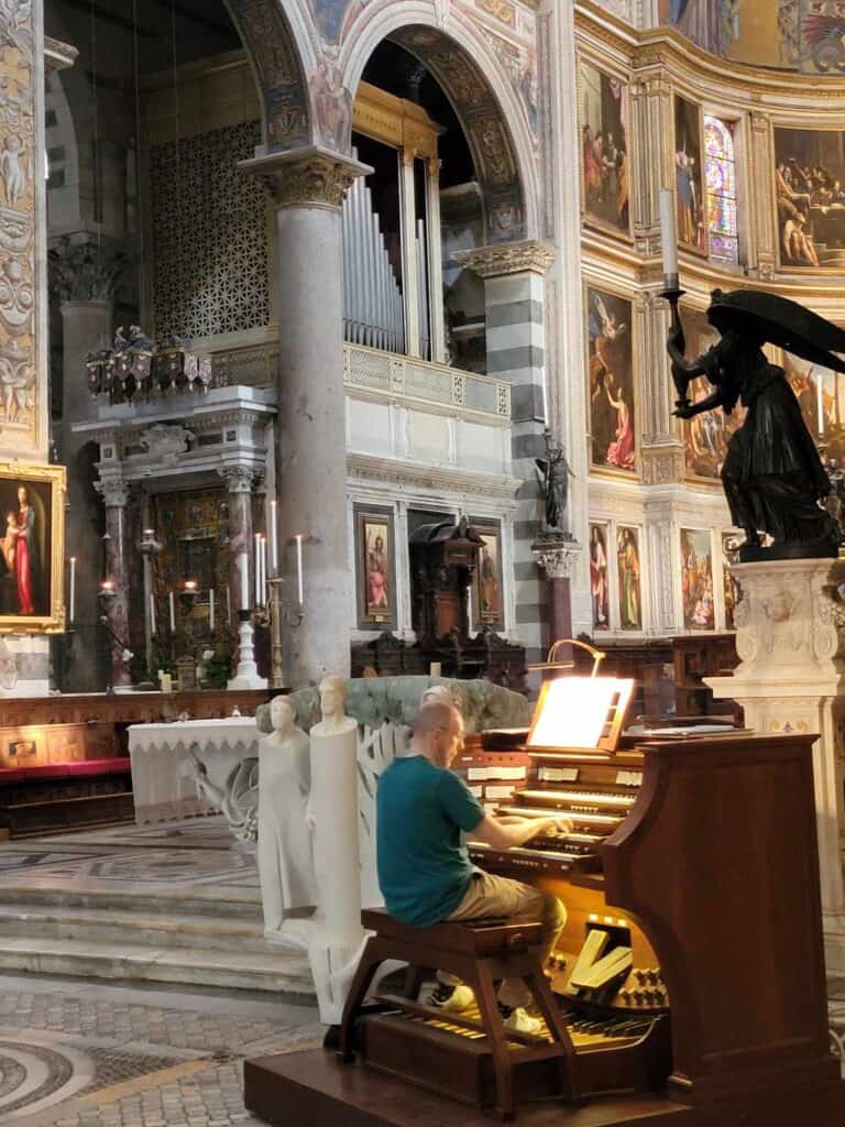 A man playing the organ inside the cathedral