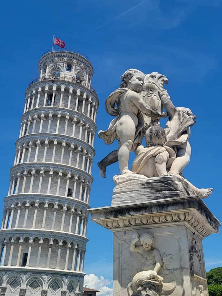 The Leaning Tower of Pisa and a statue of cherubs