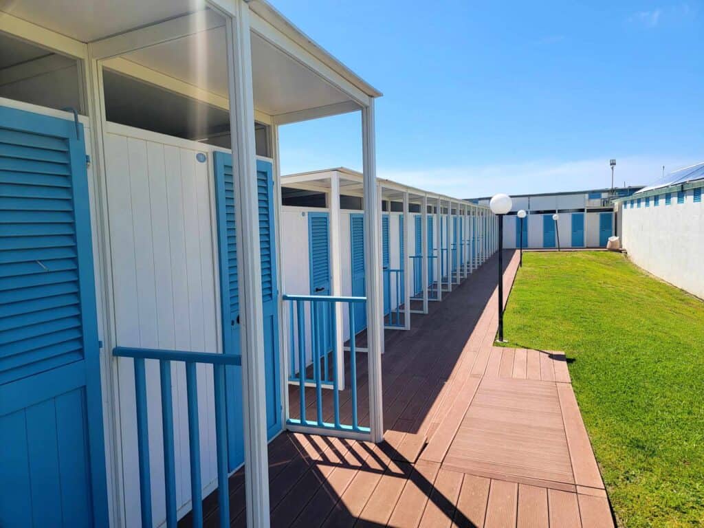 A row of blue and white beach cabanas