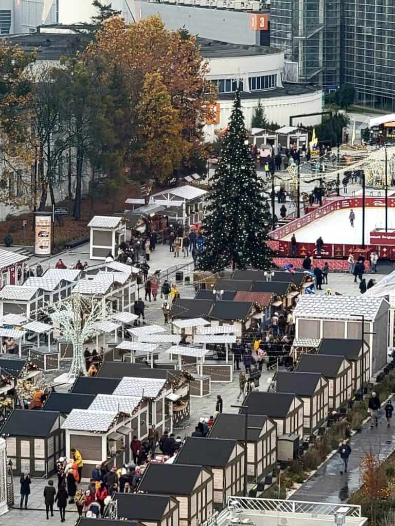 Rows of market huts and an ice skating rink seen from above