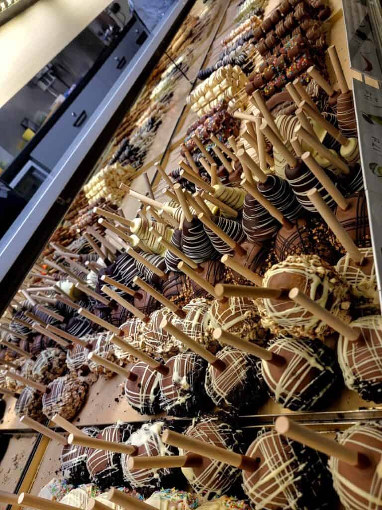 Rows and rows of chocolate covered fruit on a stick