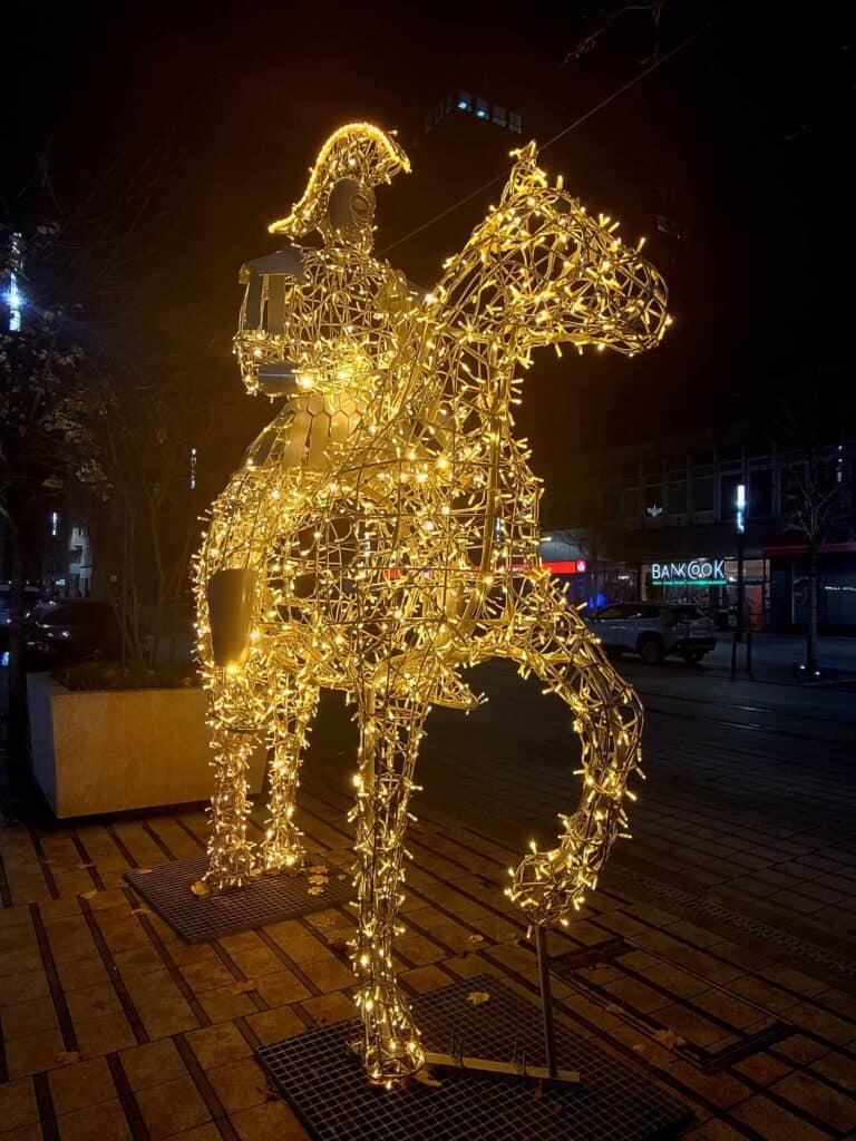 A horse and rider made of tiny white lights