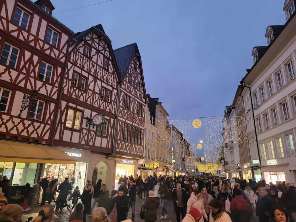 A row of timbered houses and a crowd of people