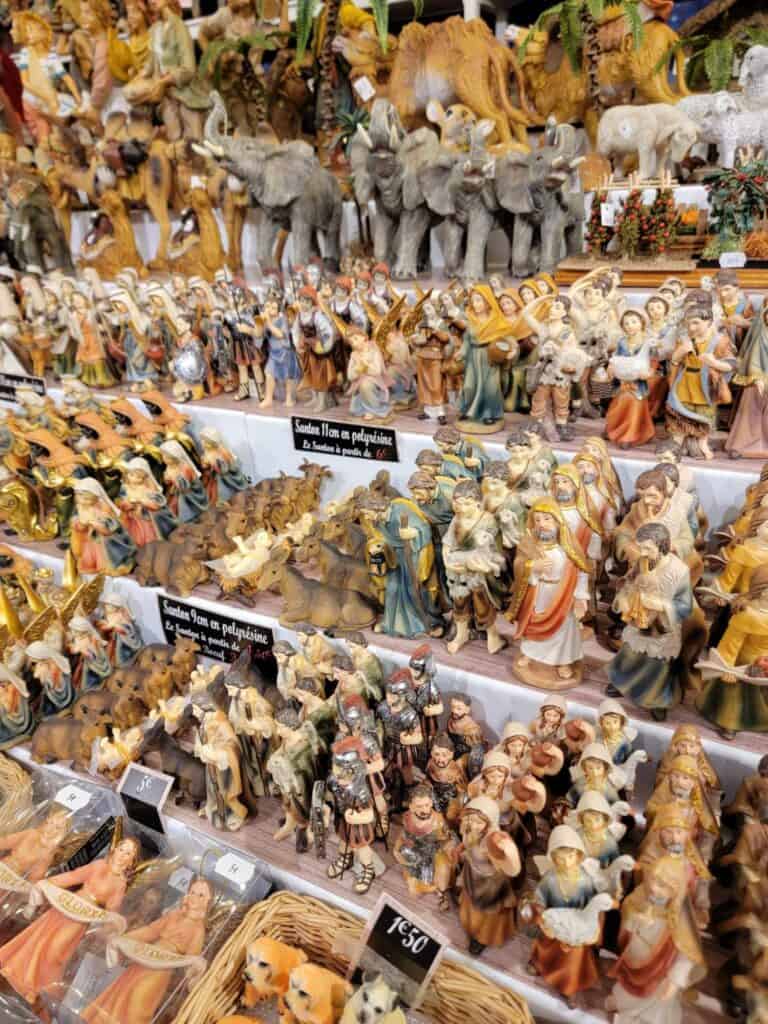 Rows of figures for small nativity scenes for sale - angels, wise men, sheep, camels, donkeys, people, and elephants