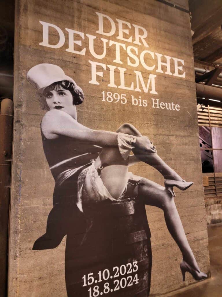 German film actress Marlene Dietrich in a top hat and stockings vamping on a movie poster