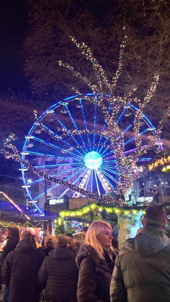 A Ferris wheel illuminated with blue lights