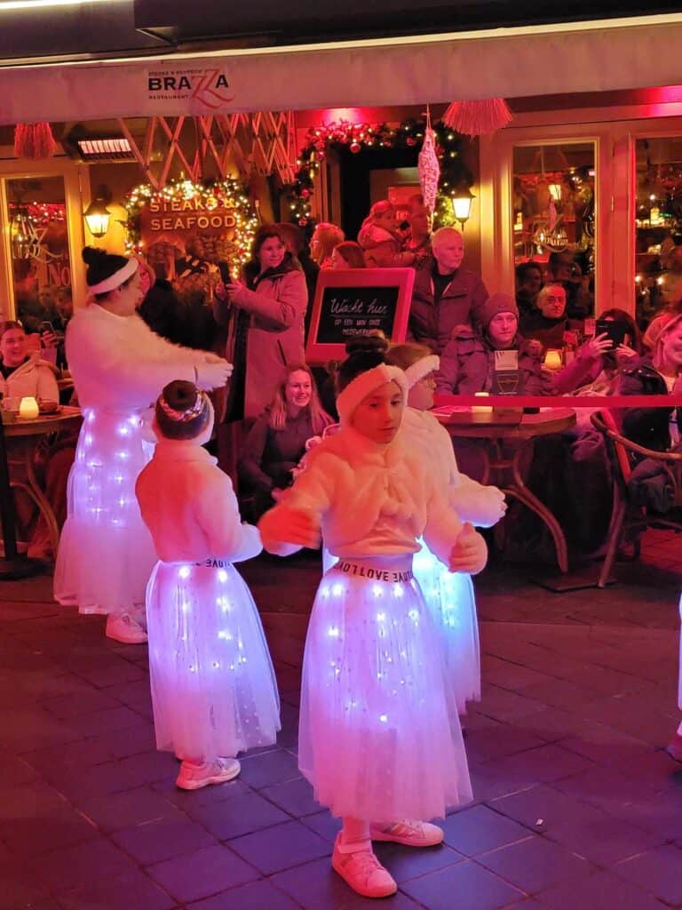 Children dressed as angels with little white lighted skirts