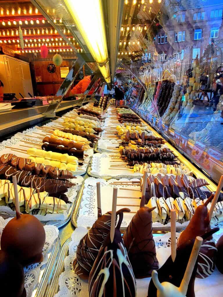 Rows of chocolate covered fruit on sticks