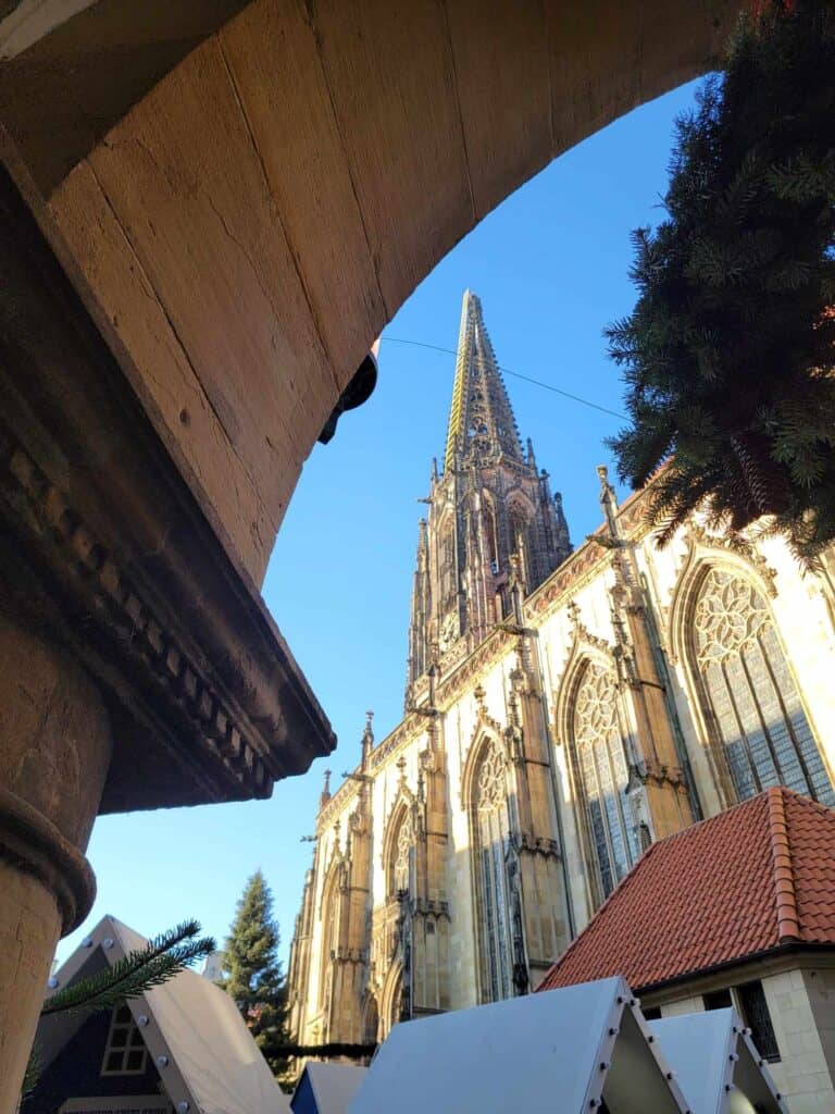 The spire of a gothic church framed by a stone arch