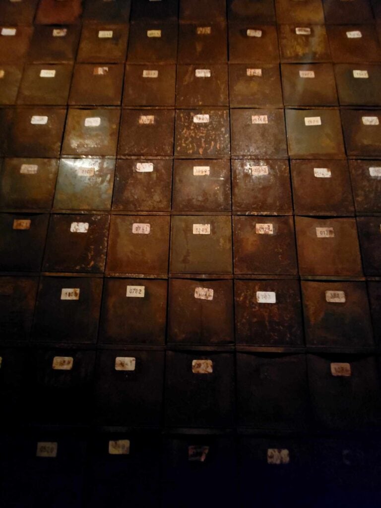 A wall of brown boxes with labels showing numbers belonging to forced laborers