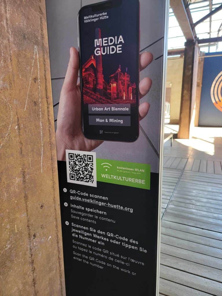 A poster advertising a media guide with a QR code