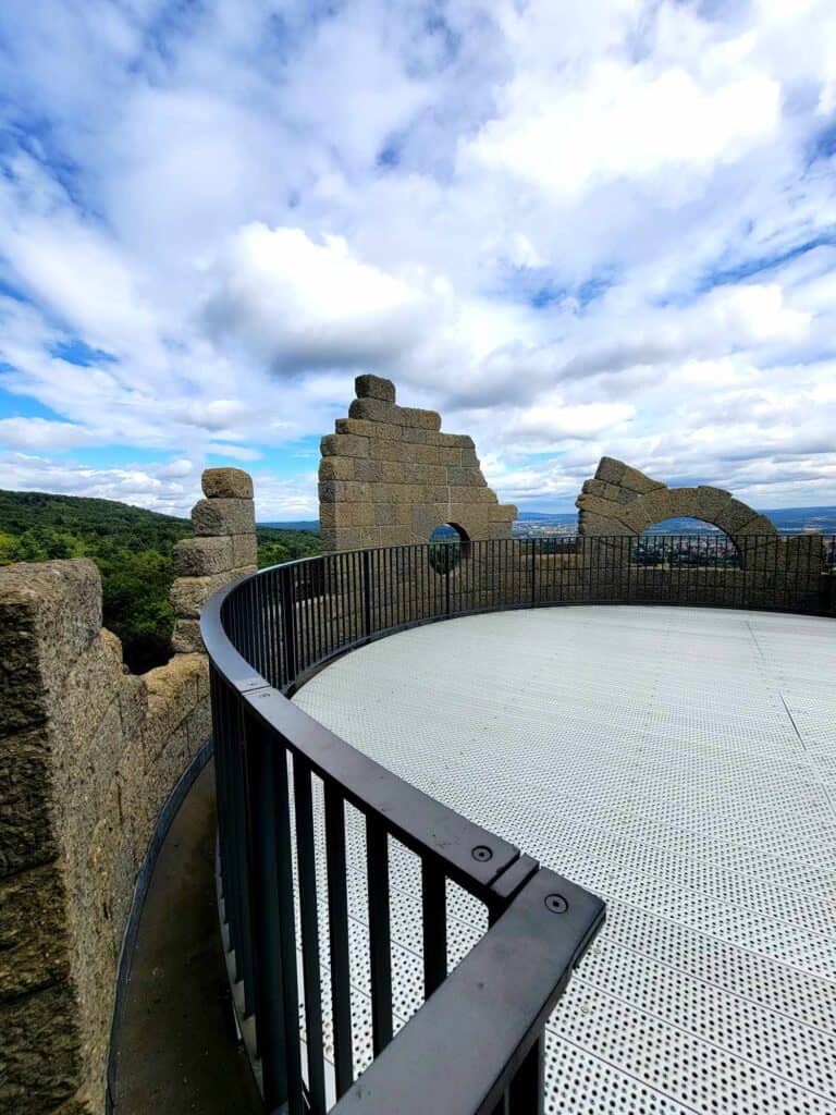 A metal fenced viewing platform on a castle turret