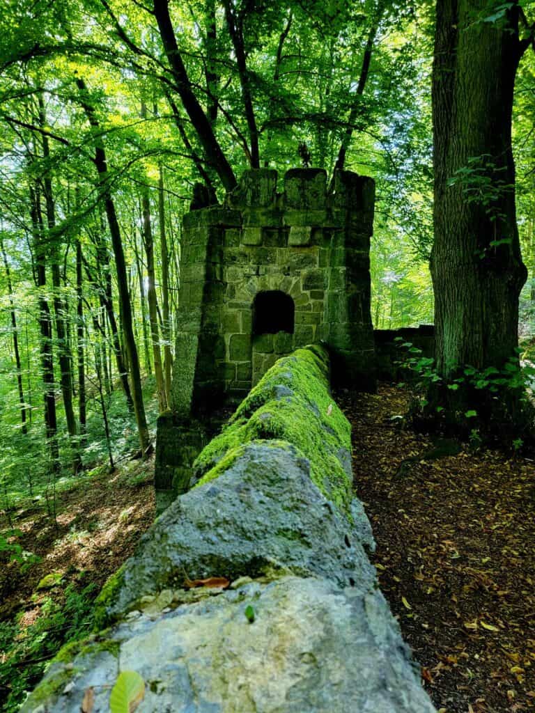 A moss covered wall and a small stone guard house