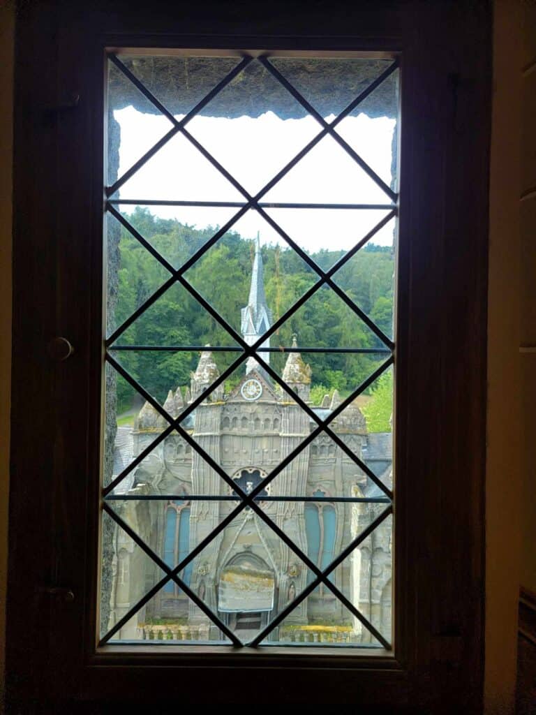 A view of a castle through a leaded window